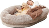 Dog and owner relaxing together on the Paws For Royalty luxury human dog bed designed for comfortable shared lounging and cuddles