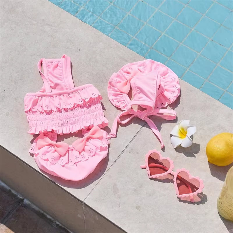 Pink dog swimsuit with matching swim cap for small dogs featuring a stylish camisole design
