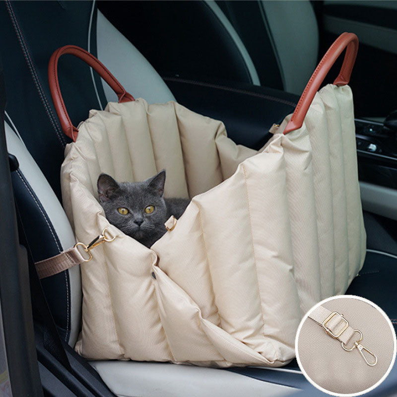 Light khaki luxury dog carrier bag with a cat resting inside during car travel, featuring a comfortable travel bed design