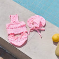 Pink dog swimsuit with matching swim cap for small dogs designed for beach trips, pool parties, and summer adventures