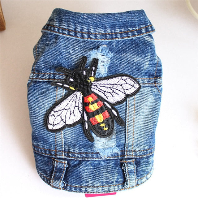 Detailed view of embroidered bee patch on a trendy denim dog jacket