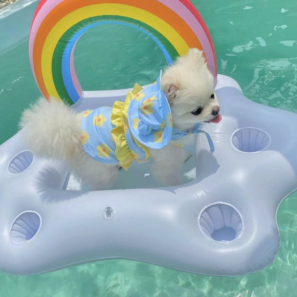 Small dog wearing a blue bikini jumpsuit in side view, featuring a comfortable one-piece design for beach and pool adventures