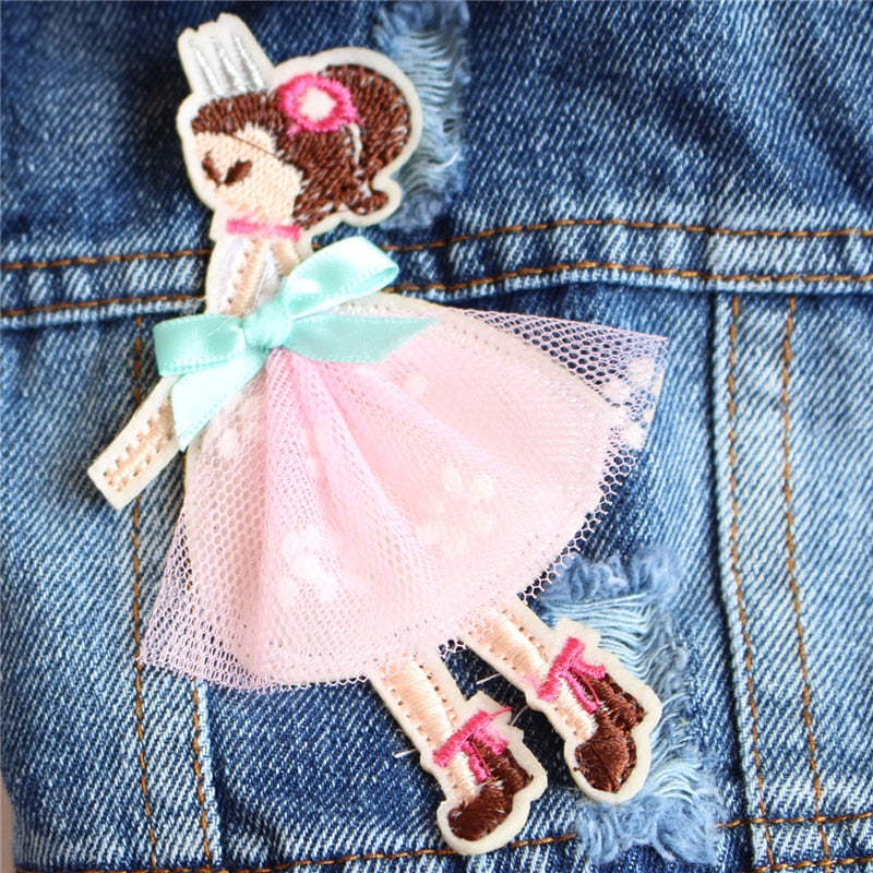 Close-up of embroidered fairy patch on a denim dog jacket for small dogs